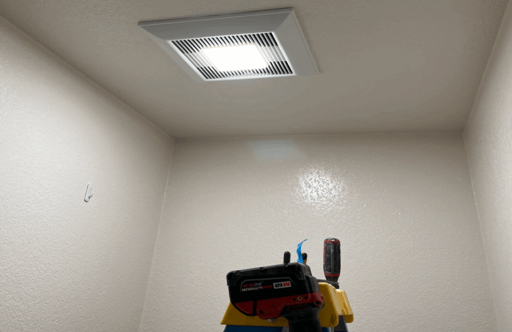 Newly installed bathroom exhaust fan with integrated LED light