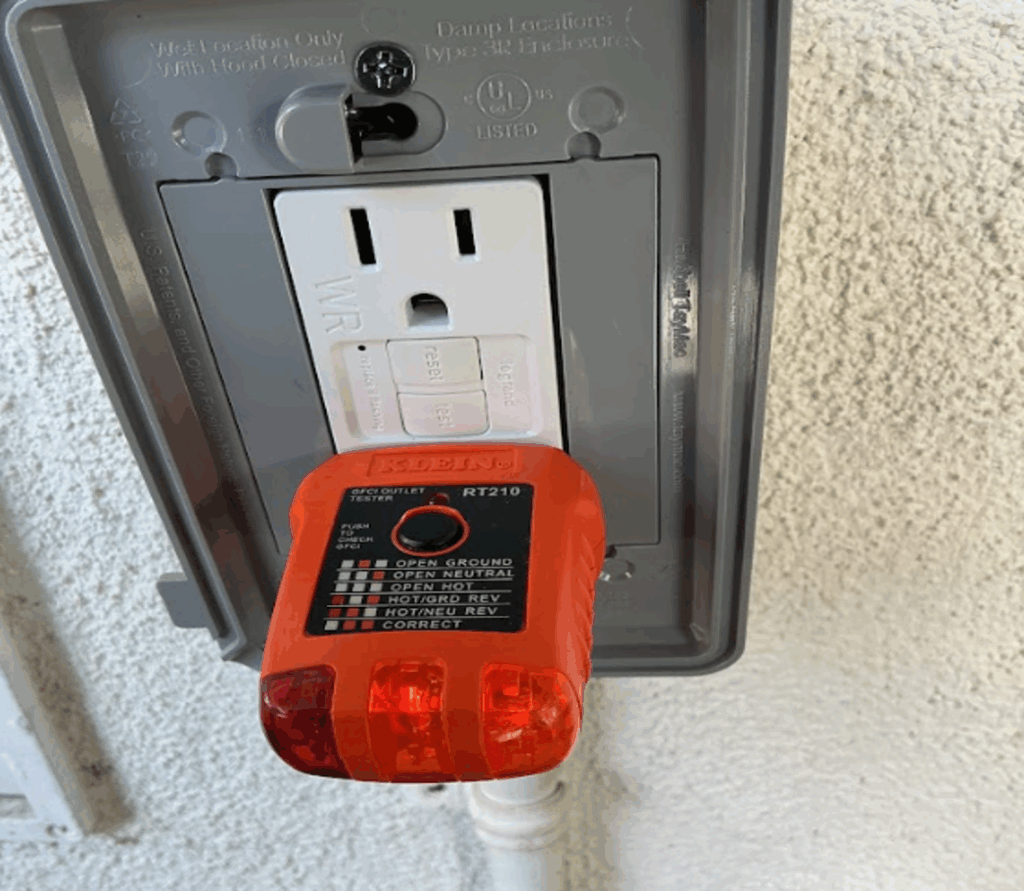Outlet tester plugged into GFCI receptacle showing correct wiring.