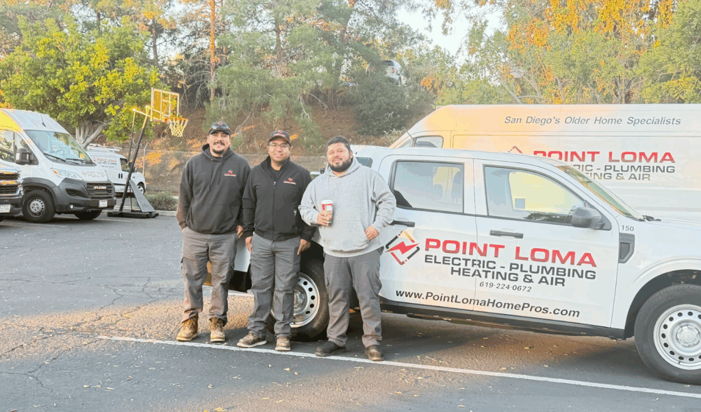 Three service technicians standing in front of a Point Loma Electric, Plumbing, Heating & Air service truck.