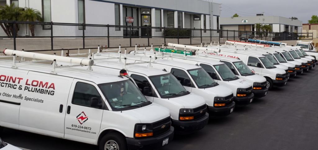 Fleet of Point Loma Home Pros service vans lined up in the parking lot