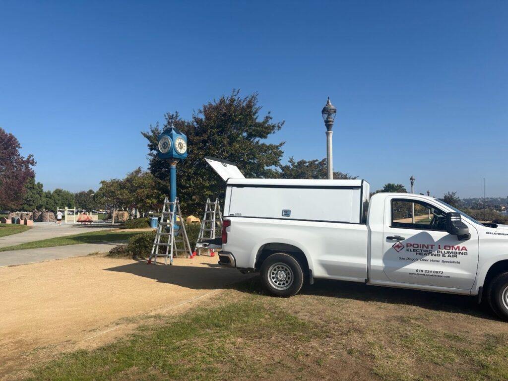 Point Loma Electric, Plumbing, Heating & Air service truck parked at a community park