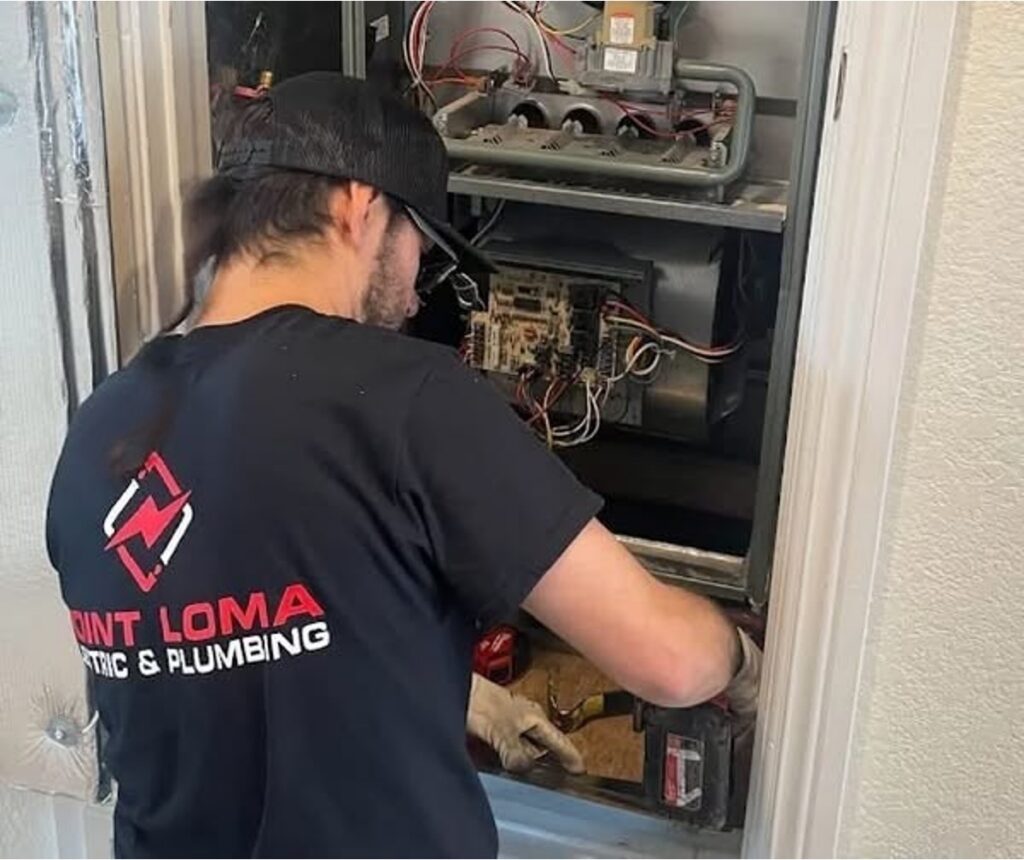 Point Loma technician inspecting and servicing the internal components of a furnace