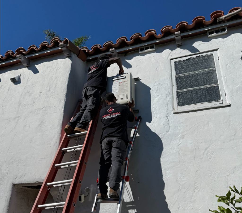 Two technicians are installing a panel on the exterior wall