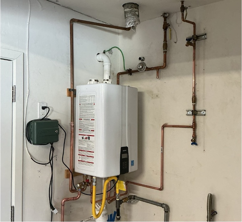 Well-installed tankless water heater with copper piping and exhaust in a utility space