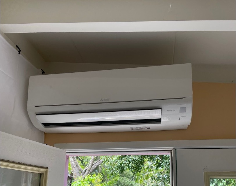 A Mitsubishi Electric mini-split indoor air handler mounted on the wall of a San Diego home.