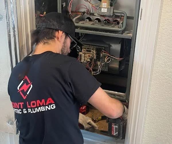Point Loma Home Pros technician inspecting HVAC components during a professional service visit.
