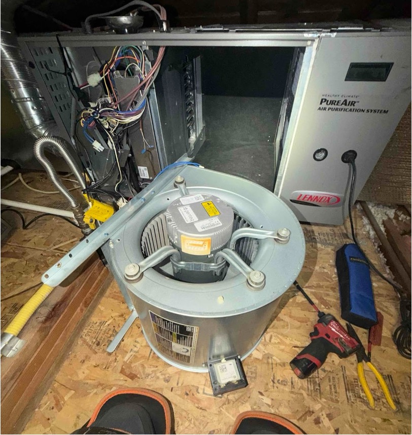 Point Loma Home Pros technician removing a blower motor from an air handler during an HVAC repair service