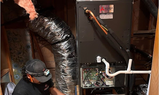 Point Loma Home Pros technician servicing a furnace unit.