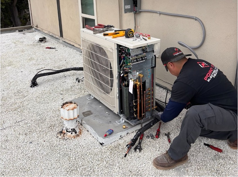 Point Loma Home Pros technician installing a mini-split outdoor condenser unit on a home rooftop