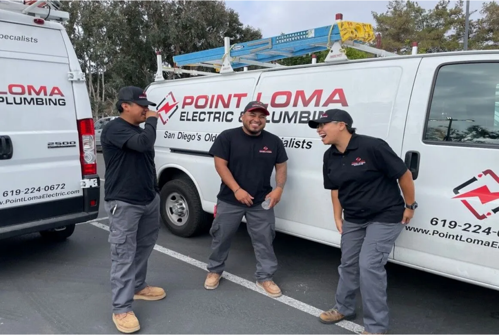 Three Point Loma Home Pros technicians in uniform sharing a laugh in front of branded service vans