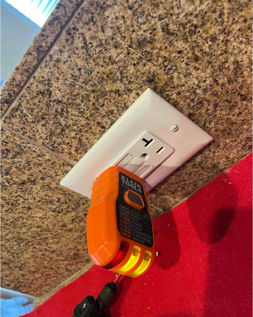 Chula Vista electrician testing a kitchen GFCI outlet for proper grounding