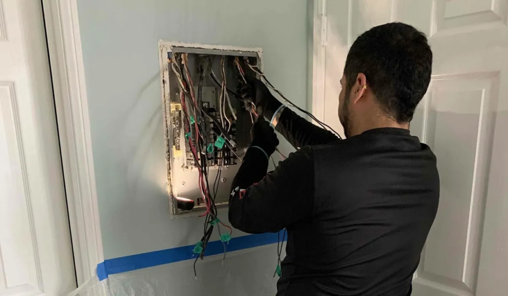 Licensed Del Mar electrician wiring a residential breaker panel during a full panel replacement