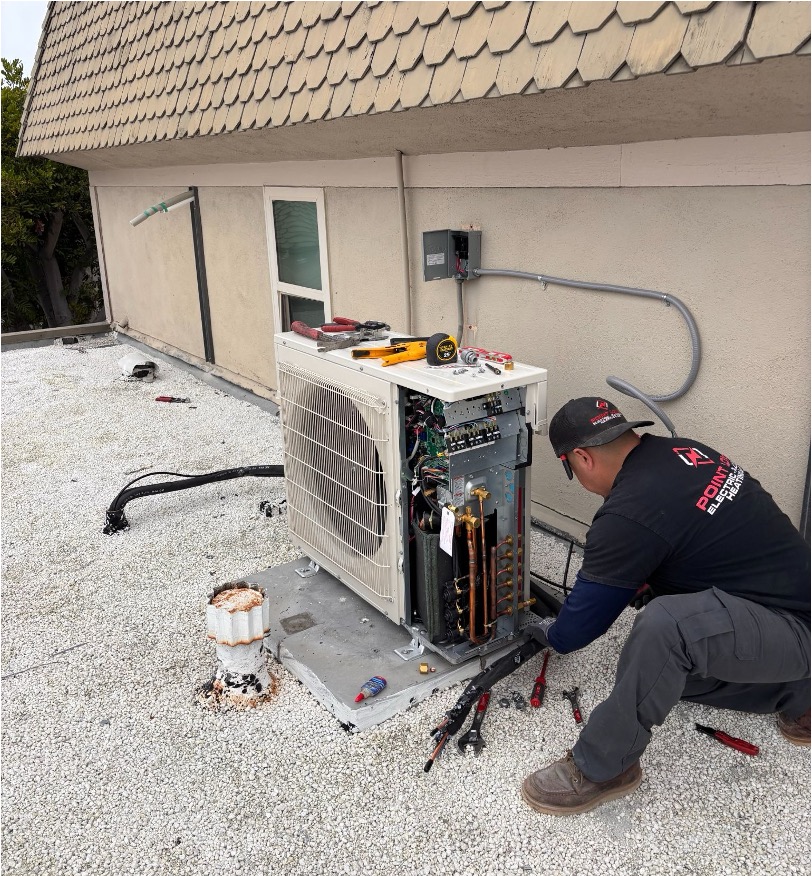 Point Loma Home Pros technician performing HVAC repair on a mini split outdoor unit in Vista.