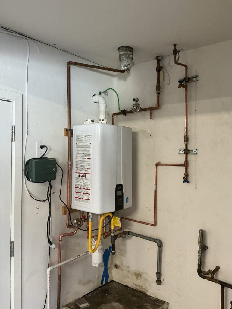 Professionally installed tankless water heater with the gas, electrical, and venting connections required for a complete replacement job