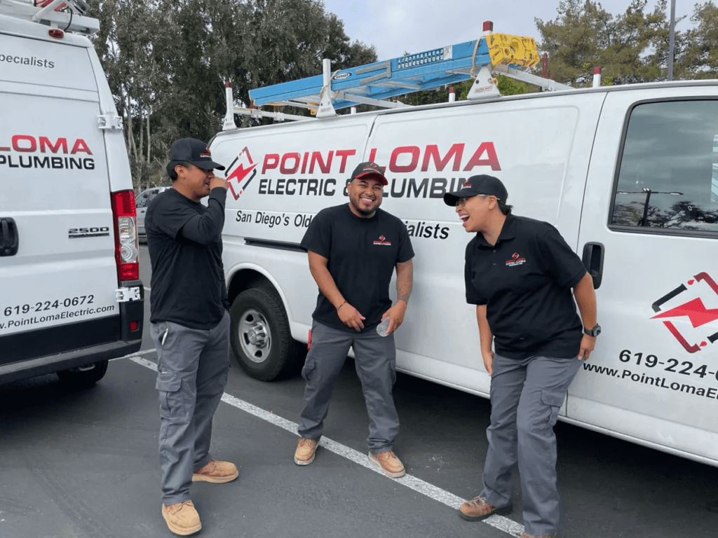 Three Point Loma Home Pros electricians in front of branded service vans