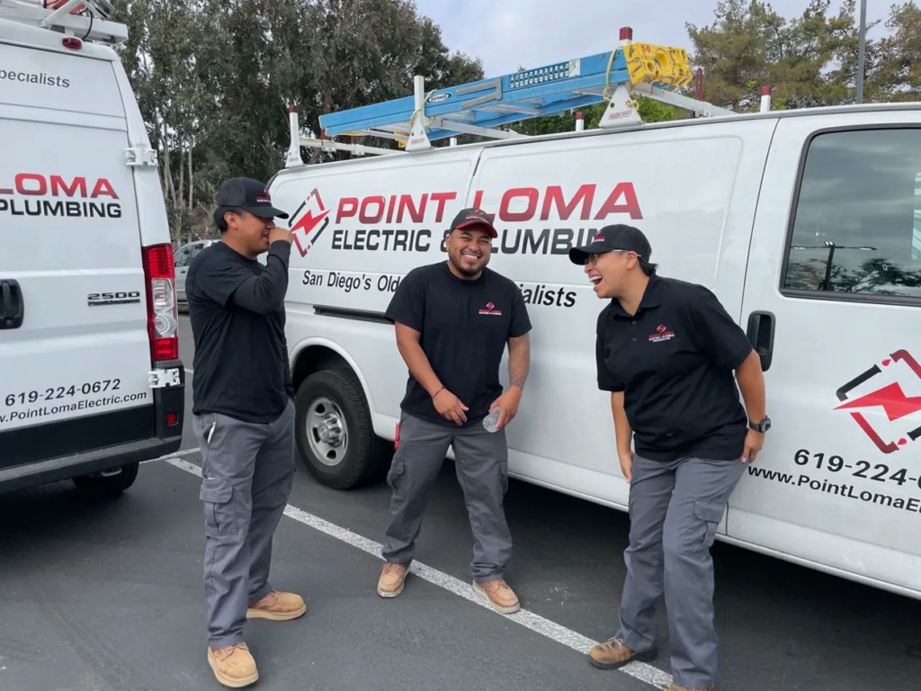 Three Point Loma Home Pros electricians in front of branded service vans