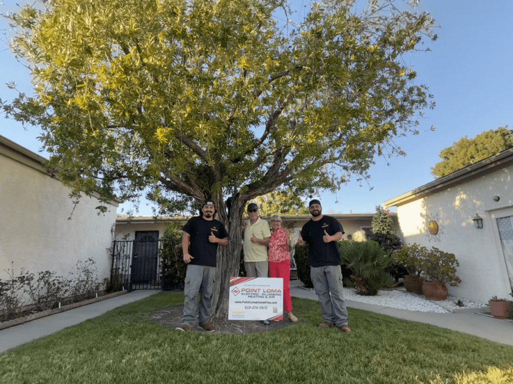 Two Point Loma Home Pros technicians with homeowners after completing a service call