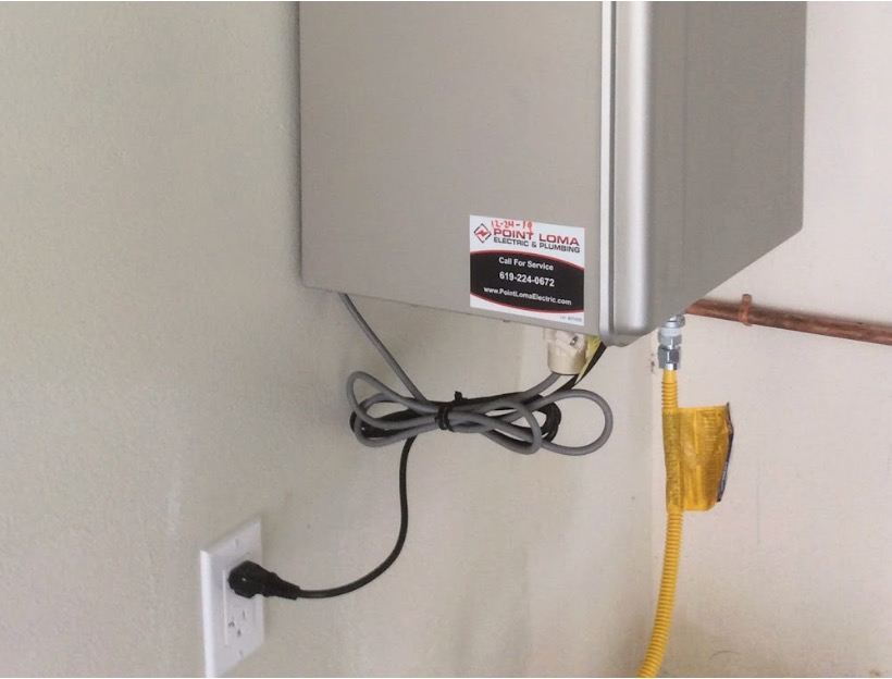 A close-up of a residential electrical panel with circuit breakers, mounted on an interior wall.