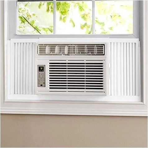 A white window air conditioner unit installed in a residential window.