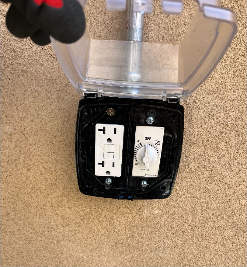 GFCI outlet with test and reset buttons installed in a weatherproof outdoor cover