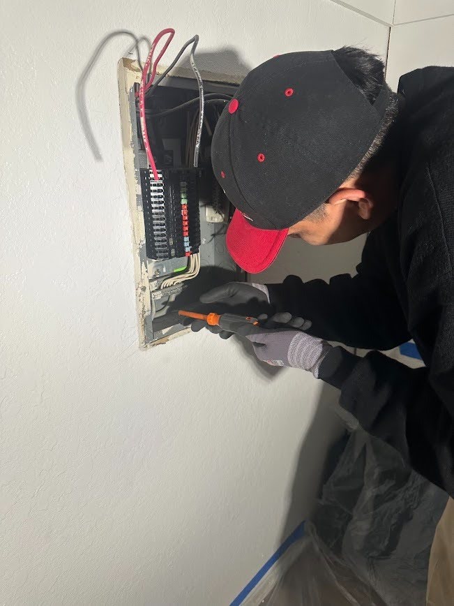 An electrician carrying out electrical panel replacement.