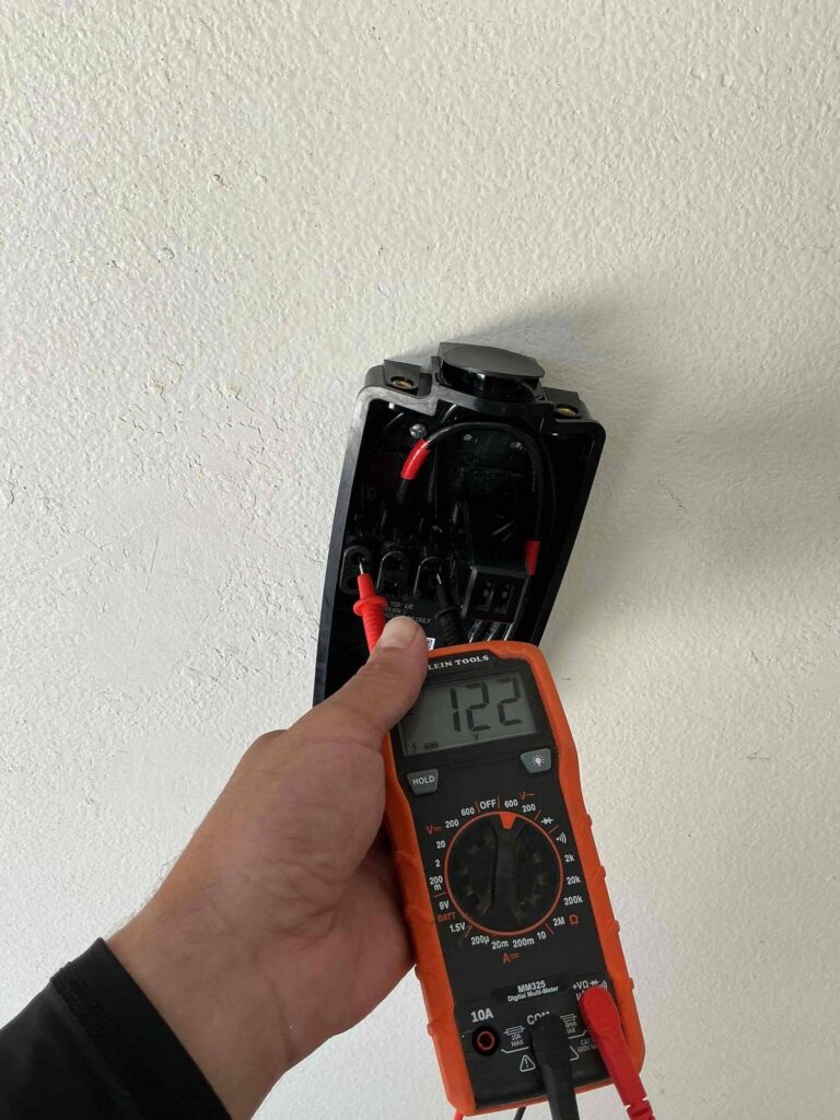 An electrician installing an EV charger in a La Mesa, CA home.