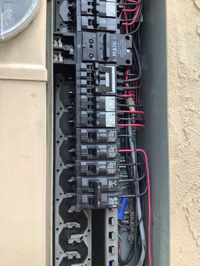 Interior of an open residential circuit breaker panel.