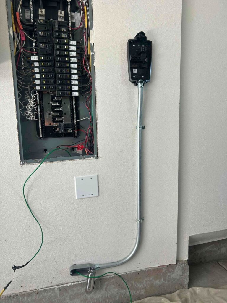 Open electrical panel with new conduit running to a dedicated circuit for an EV charger.