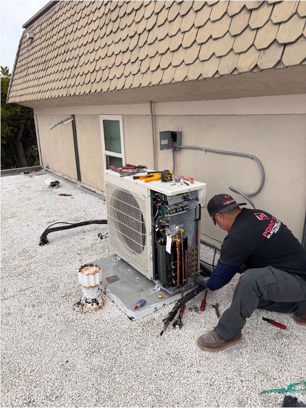 Point Loma Home Pros specialist working on an AC system