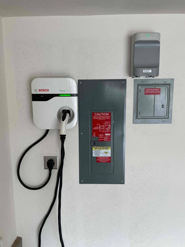 Wall-mounted plug-in Level 2 EV charger connected to a 240-volt outlet.